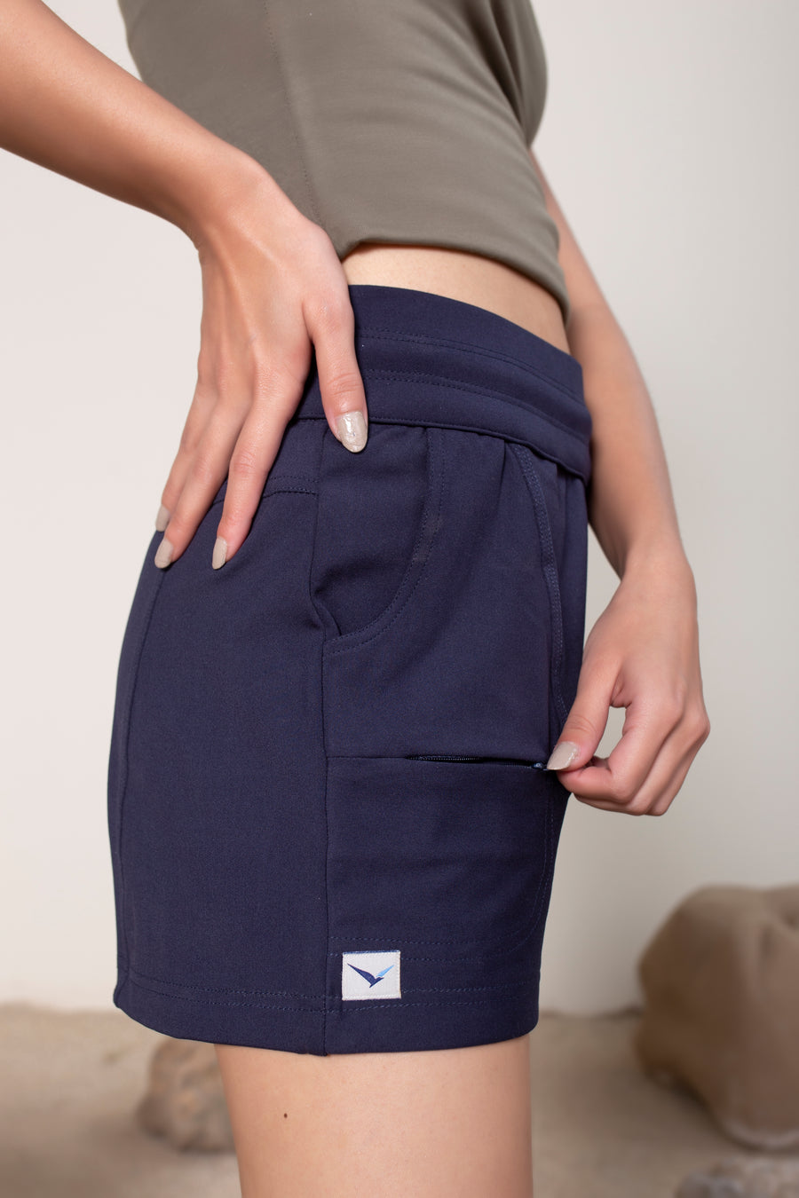 Women's Terra Shorts Navy | VOLO Apparel | A blend of technology, function, and style. The Terra shorts are designed and ready for every active opportunity that comes your way. Your first women's shorts with deep pockets, a snap button smart phone pocket, a zippered key pocket, and a hidden zippered back pocket.  High waisted, great for climbing, yoga, training, running and chilling.