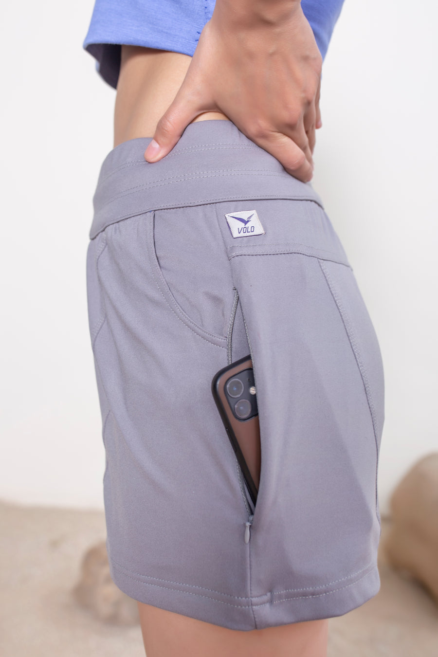 Women's Terra Shorts Silver Gray | VOLO Apparel | A blend of technology, function, and style. The Terra shorts are designed and ready for every active opportunity that comes your way. Your first women's shorts with deep pockets, a snap button smart phone pocket, a zippered key pocket, and a hidden zippered back pocket.  High waisted, great for climbing, yoga, training, running and chilling.