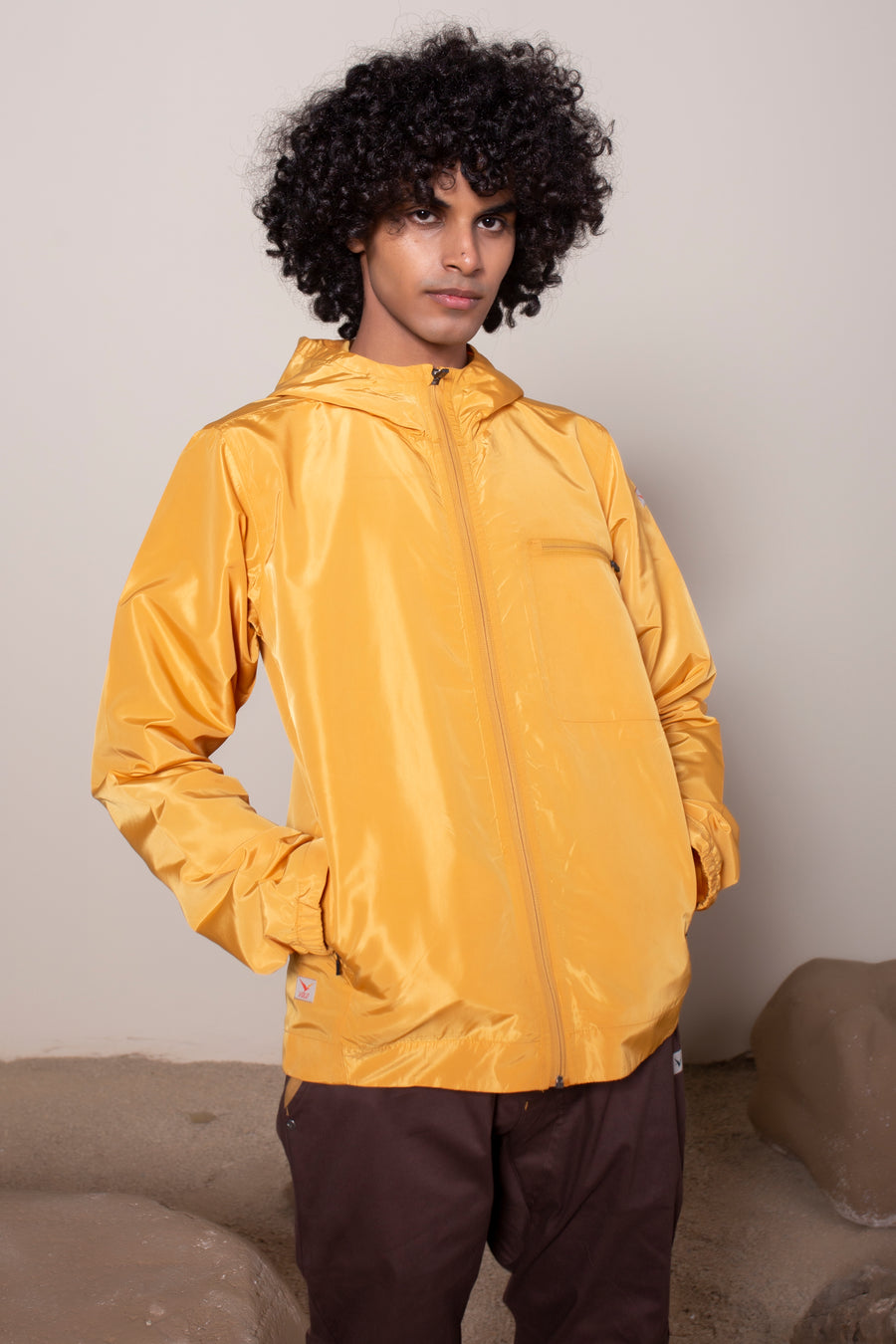 Men's Windansea Jacket in Golden | VOLO Apparel | The ultimate all year jacket, an ultralight hooded windbreaker, crafted with the revolutionary memory fabric and five pockets. This jacket is full of features, water repellant, three zipper pockets, UPF 50 protection from the sun and tailored fit to look super stylish while being ready for any adventure.