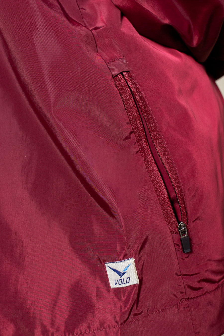 Women's Windansea Jacket in Maroon | VOLO Apparel | The ultimate all year jacket, an ultralight hooded windbreaker, crafted with the revolutionary memory fabric and five pockets. This jacket is full of features, water repellant, three zipper pockets, UPF 50 protection from the sun and tailored fit to look super stylish while being ready for any adventure.