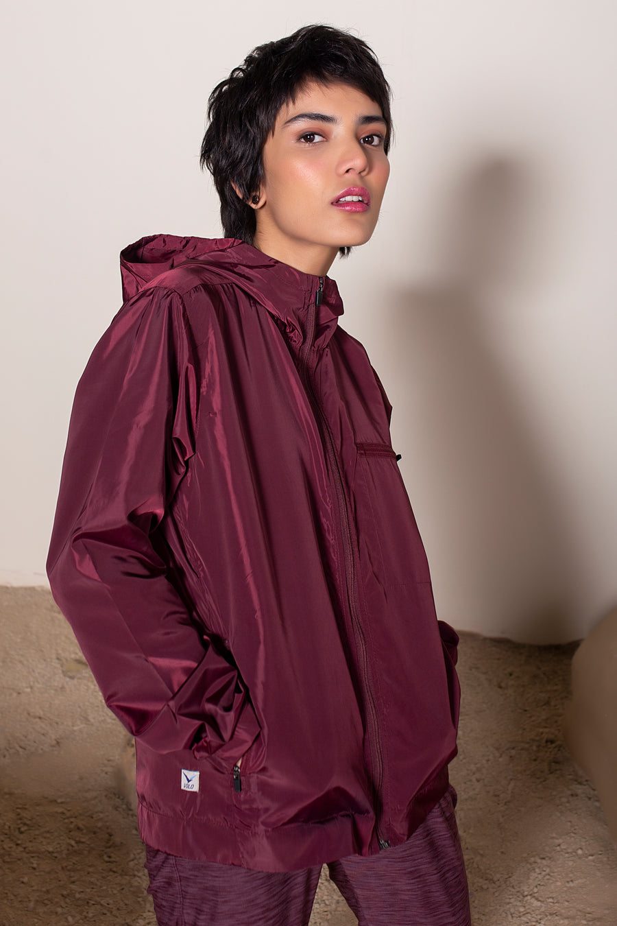 Women's Windansea Jacket in Maroon | VOLO Apparel | The ultimate all year jacket, an ultralight hooded windbreaker, crafted with the revolutionary memory fabric and five pockets. This jacket is full of features, water repellant, three zipper pockets, UPF 50 protection from the sun and tailored fit to look super stylish while being ready for any adventure.