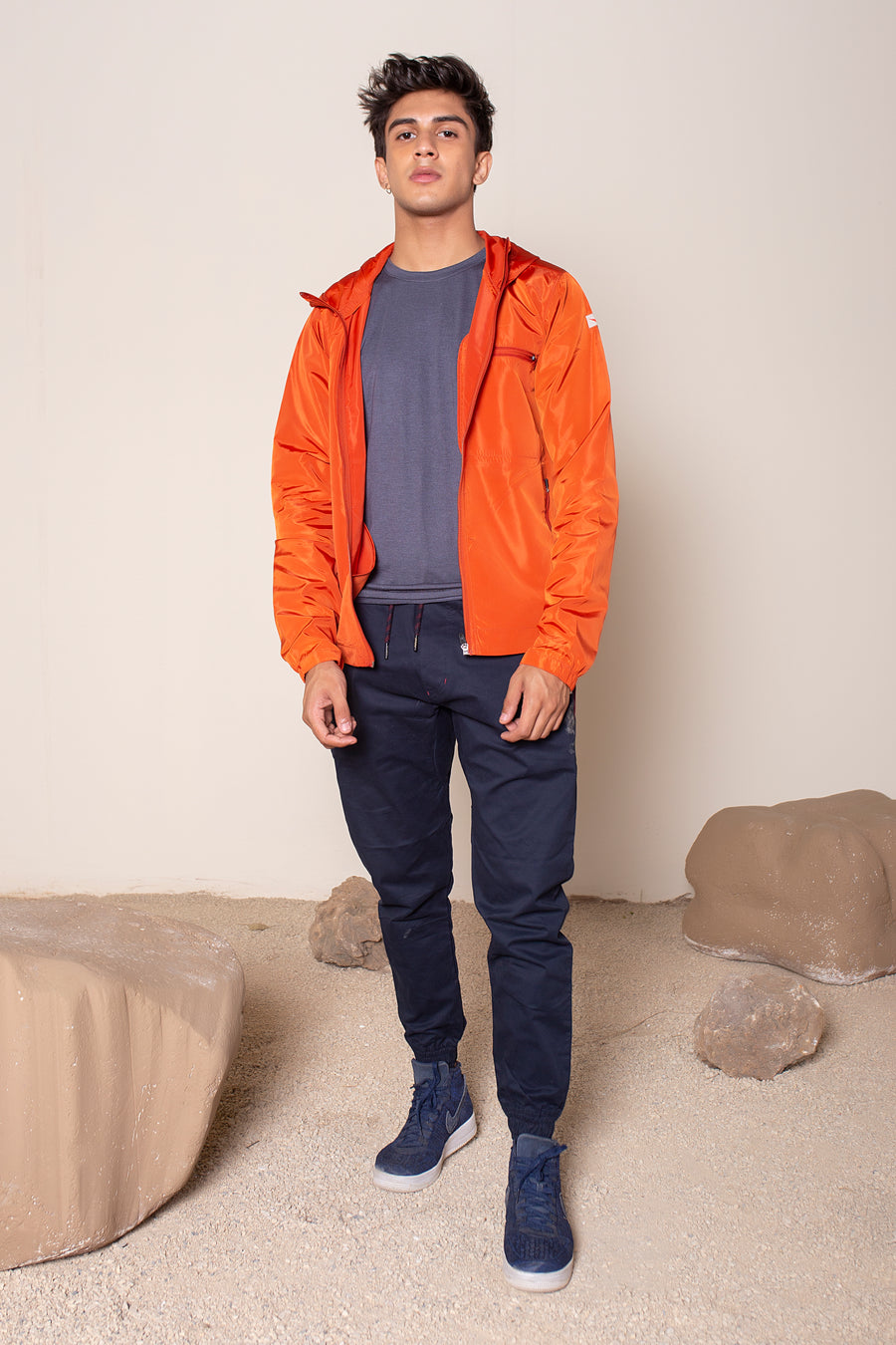 Men's Windansea Jacket in Orange | VOLO Apparel | The ultimate all year jacket, an ultralight hooded windbreaker, crafted with the revolutionary memory fabric and five pockets. This jacket is full of features, water repellant, three zipper pockets, UPF 50 protection from the sun and tailored fit to look super stylish while being ready for any adventure.