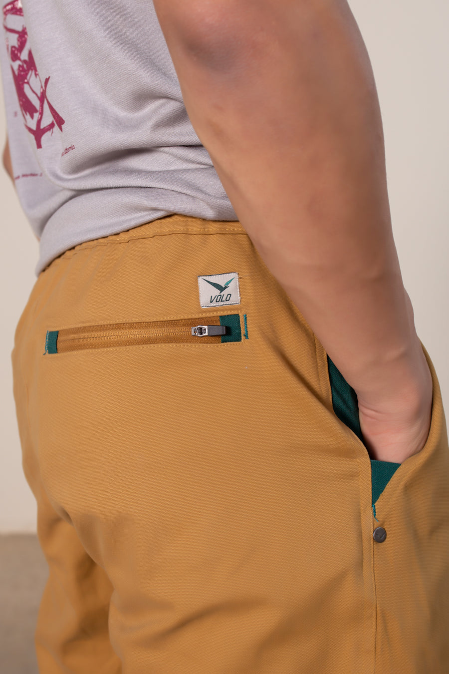Men's Sequoia Canvas Pant in Gold | VOLO Apparel | Made with an ultra durable stretch cotton canvas, the Sequoia Canvas Pant is our ultimate six pocket lifestyle pant. Featuring a modern slim fit and a 33 inch inseam, a 3 point gusset, snap button security pockets, 2 zipper pockets and the comfort of durable canvas, these are your go to adventure pants that can handle anything you throw at them.