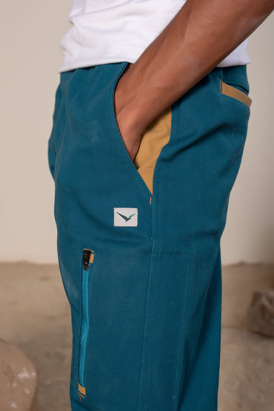 Men's Sequoia Canvas Pant in Teal | VOLO Apparel | Made with an ultra durable stretch cotton canvas, the Sequoia Canvas Pant is our ultimate six pocket lifestyle pant. Featuring a modern slim fit and a 33 inch inseam, a 3 point gusset, snap button security pockets, 2 zipper pockets and the comfort of durable canvas, these are your go to adventure pants that can handle anything you throw at them.