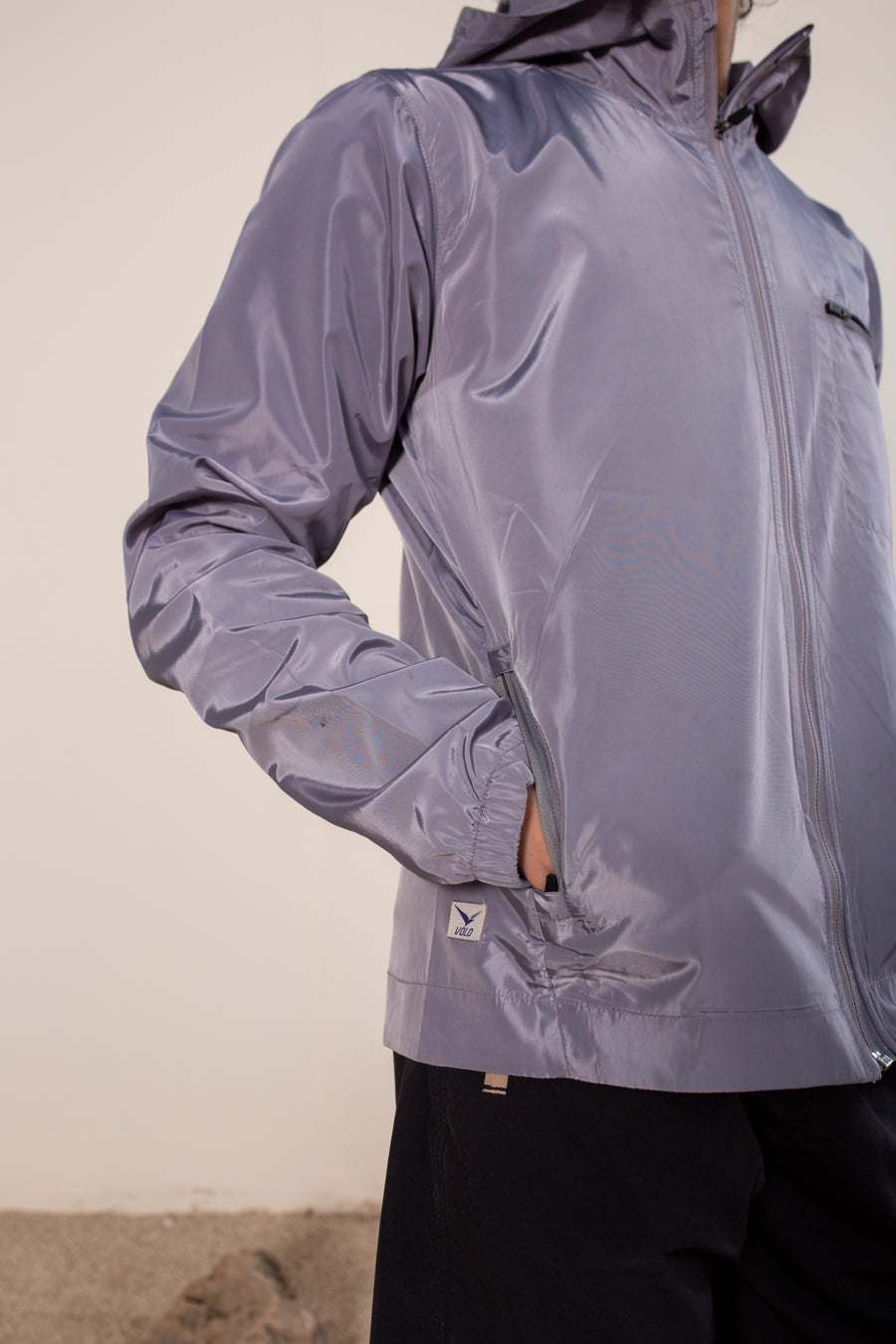 Women's Windansea Jacket in Silver Gray | VOLO Apparel | The ultimate all year jacket, an ultralight hooded windbreaker, crafted with the revolutionary memory fabric and five pockets. This jacket is full of features, water repellant, three zipper pockets, UPF 50 protection from the sun and tailored fit to look super stylish while being ready for any adventure.