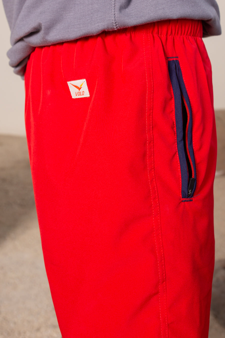 Men's Flight Shorts in Red | VOLO Apparel | Designed so you can feel fly and completely secure, the Flight Shorts 2.0 are made with an ultralight micro stretch fabric that is quick drying and comes with a three zipper pocket design. The smart pocket tech makes it so your stuff won’t bounce when you do. Reinforced stitching so it can handle everything you will throw at it. The one short for your every adventure.