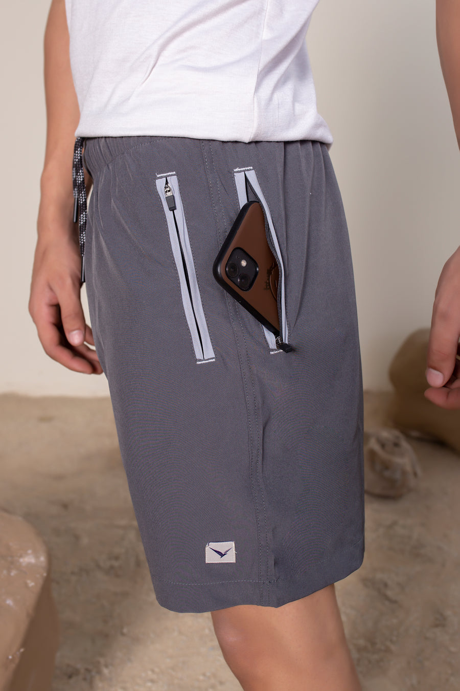 Men's Flight Shorts in Dark Gray | VOLO Apparel | Designed so you can feel fly and completely secure, the Flight Shorts 2.0 are made with an ultralight micro stretch fabric that is quick drying and comes with a three zipper pocket design. The smart pocket tech makes it so your stuff won’t bounce when you do. Reinforced stitching so it can handle everything you will throw at it. The one short for your every adventure.
