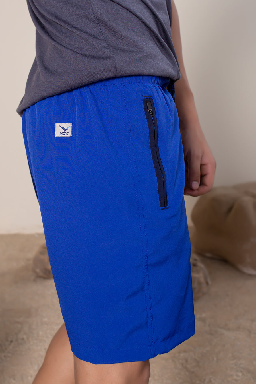 Men's Flight Shorts in Lapis Blue | VOLO Apparel | Designed so you can feel fly and completely secure, the Flight Shorts 2.0 are made with an ultralight micro stretch fabric that is quick drying and comes with a three zipper pocket design. The smart pocket tech makes it so your stuff won’t bounce when you do. Reinforced stitching so it can handle everything you will throw at it. The one short for your every adventure.