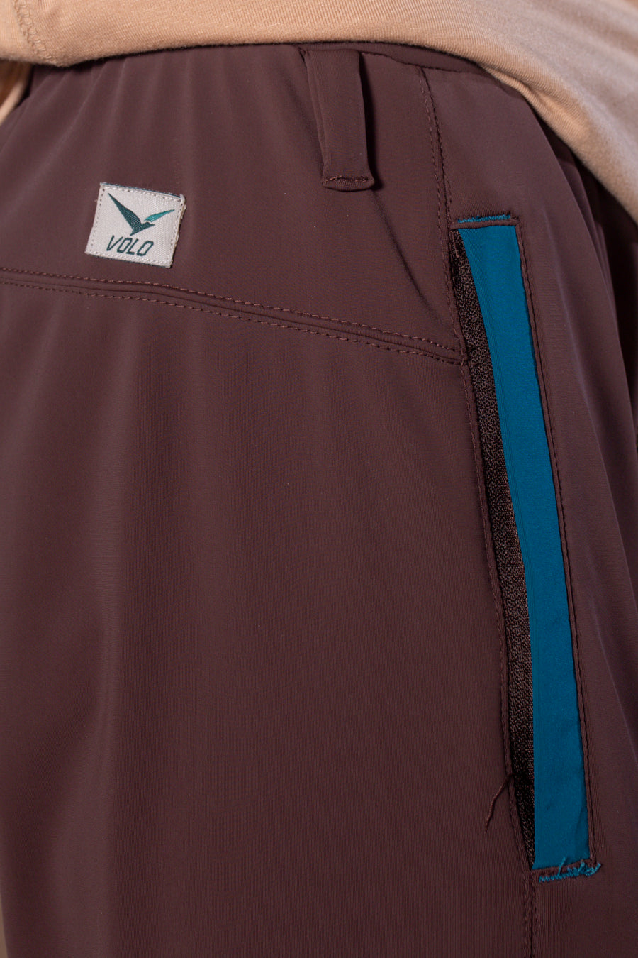Men's Wanderlust Pant Brown | VOLO Apparel | These pants are designed to give you wanderlust, an ultralight super durable athletic pant with a five pocket design, a 3 point gusset for all your movements and a high ankle tapered bottom. The revolutional Italian nylon is patented with UPF 50 protection and extreme breathability. The one pant to go everywhere and do everything!